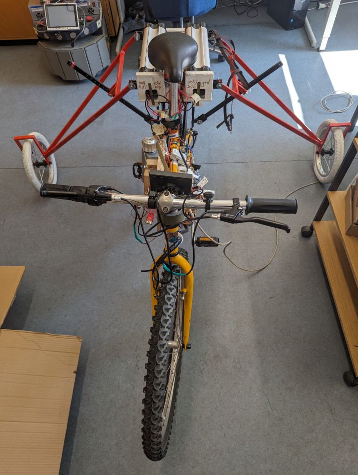 The same bicycle with the front wheel turned to the right by the steering motor.